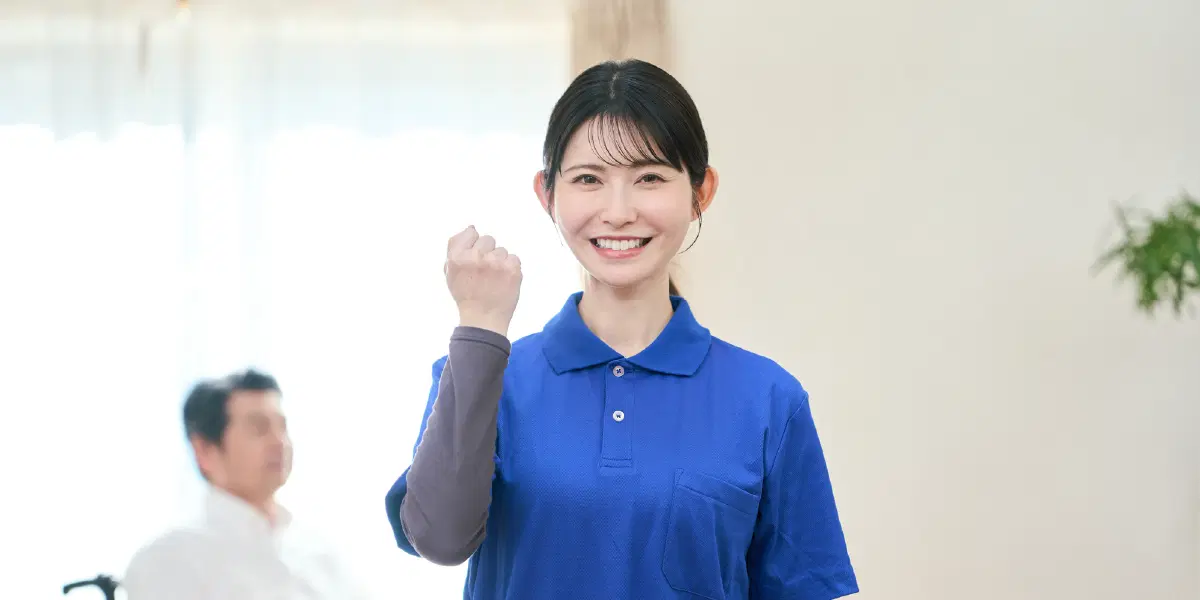 青い服を着た女性がガッツポーズしている